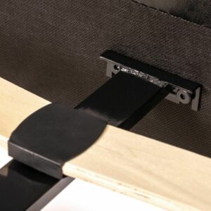 Close up of the construction of a black faux leather bed