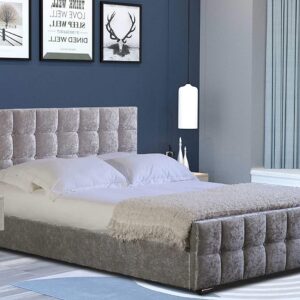 A silver ottoman bed made in a blue bedroom