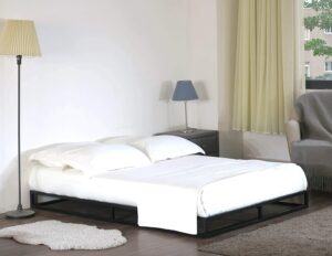 A black platform bed inside a white bedroom