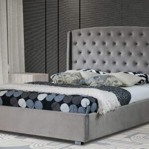 A dark grey velvet Balmain bed placed in a grey bedroom