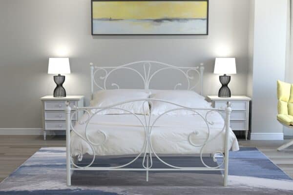forged white metal frame with white bed sheets and two lamps