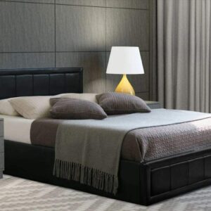 Black Leather Ottoman Bed covered with blanket and 6 pillows