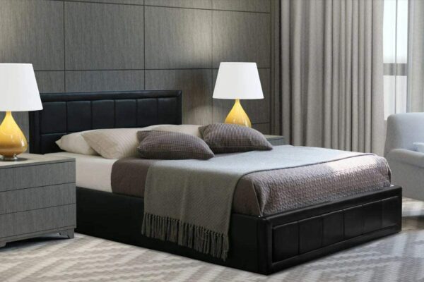 Black Leather Ottoman Bed covered with blanket and 6 pillows